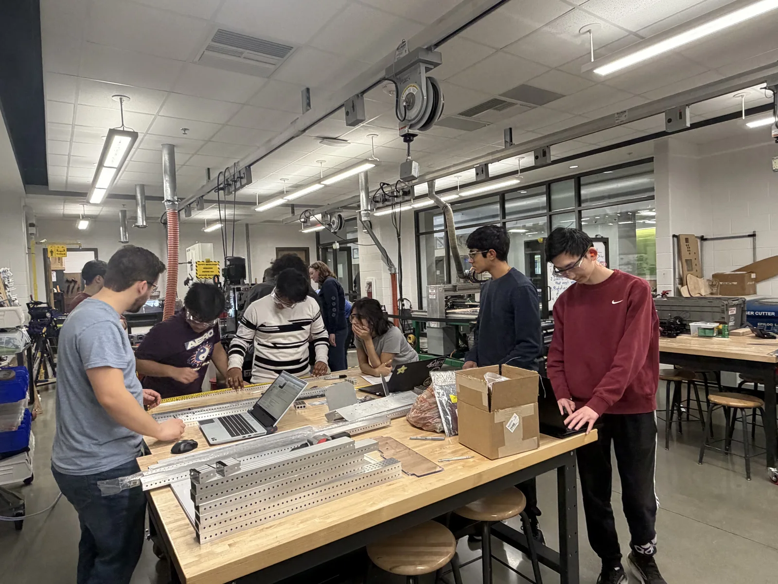 Team members designing and assembling robot components