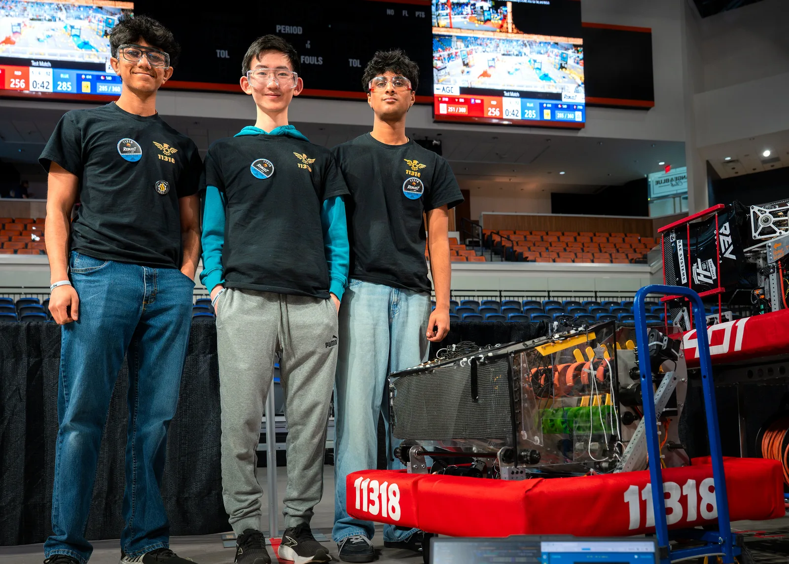 Freedom Robotics students and robot 11318 at a FIRST competition